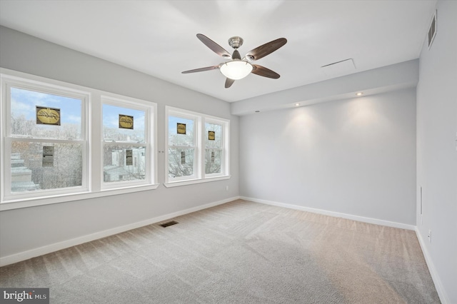 spare room featuring visible vents, baseboards, and carpet