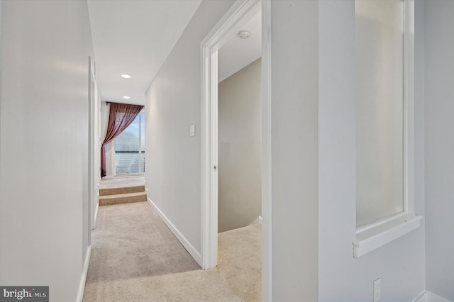 hallway with recessed lighting, carpet, and baseboards