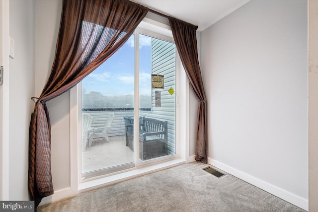 carpeted spare room featuring visible vents and baseboards