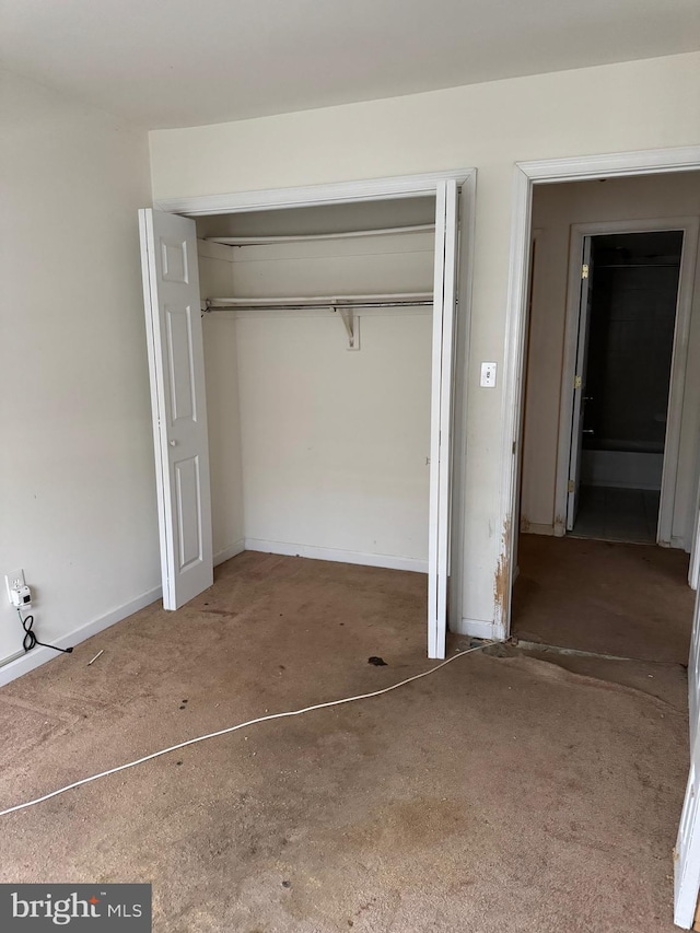 unfurnished bedroom featuring a closet and baseboards