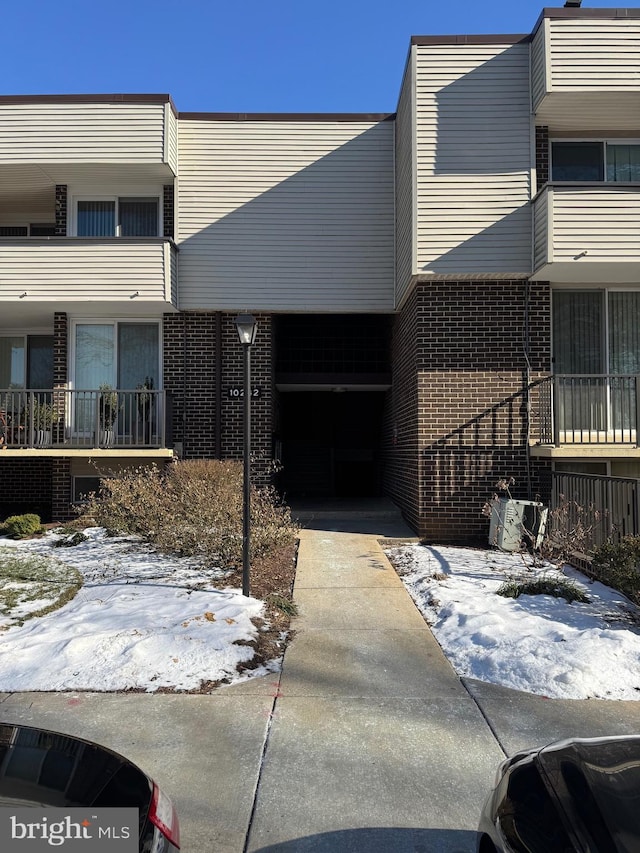 view of property with brick siding