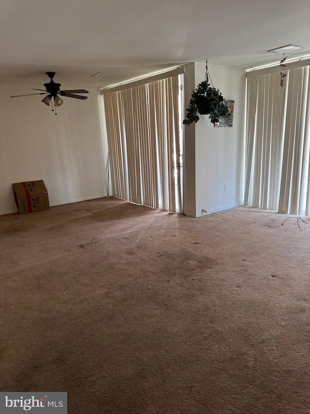 carpeted spare room with ceiling fan