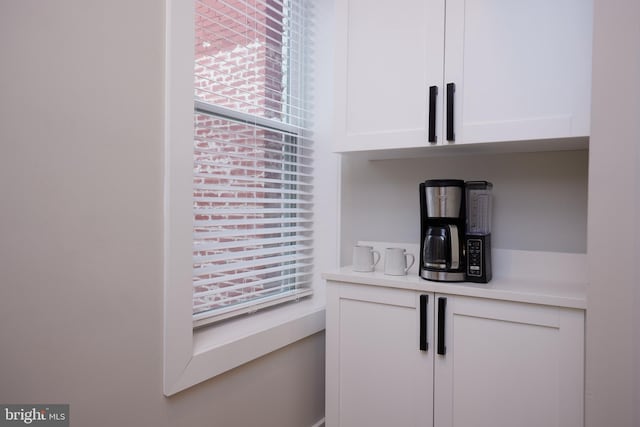 interior space featuring white cabinets and light countertops