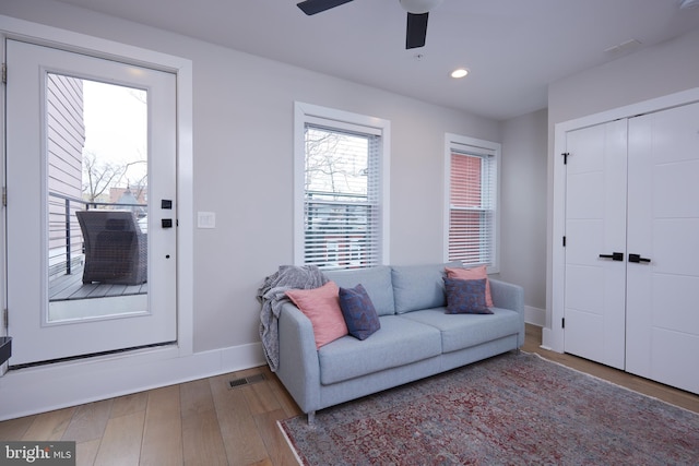 living room with wood finished floors, visible vents, baseboards, recessed lighting, and ceiling fan