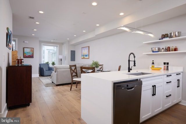 kitchen with visible vents, white cabinetry, light wood finished floors, a sink, and dishwasher