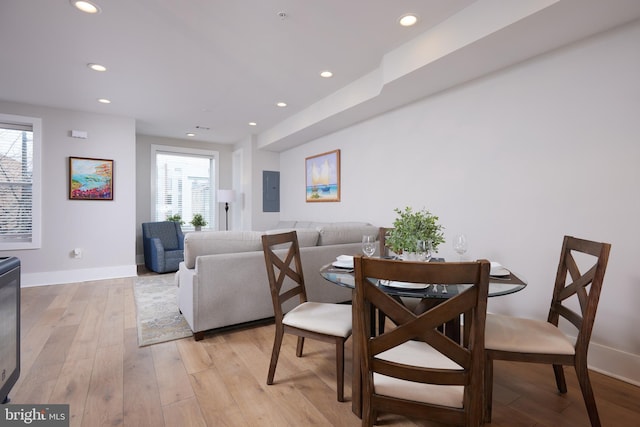 dining space featuring light wood finished floors, recessed lighting, and a wealth of natural light