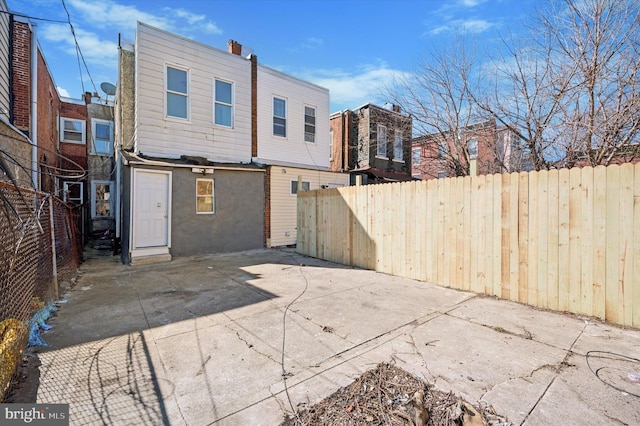 back of house featuring a patio area, stucco siding, and fence