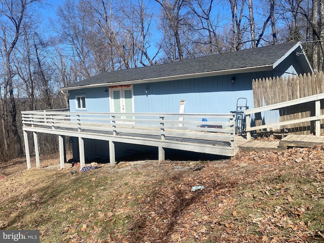 view of front of property with a deck and fence