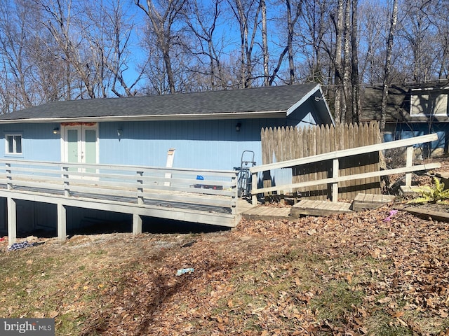 view of front of home featuring a shingled roof and fence