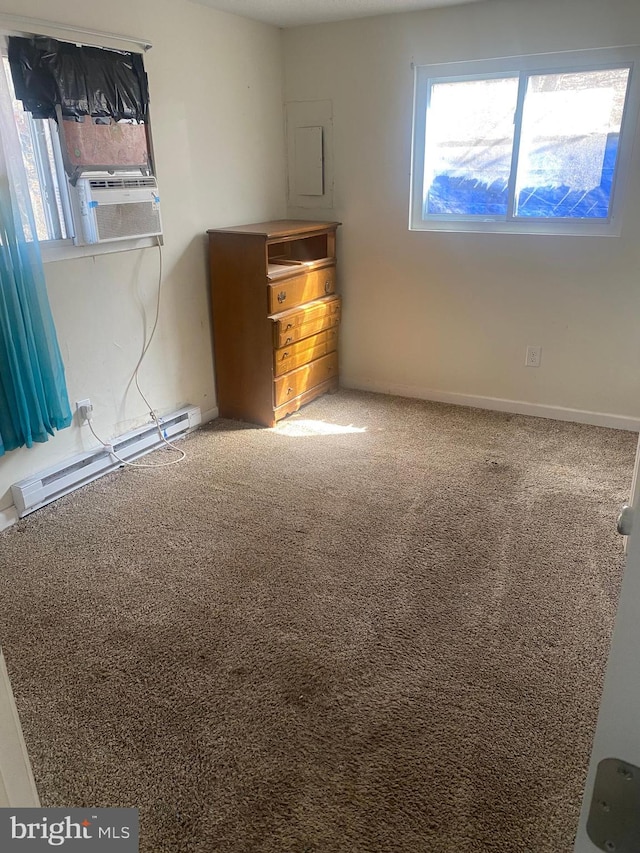 empty room with electric panel, cooling unit, carpet flooring, baseboards, and baseboard heating