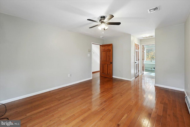 empty room featuring visible vents, baseboards, light wood-type flooring, baseboard heating, and a ceiling fan