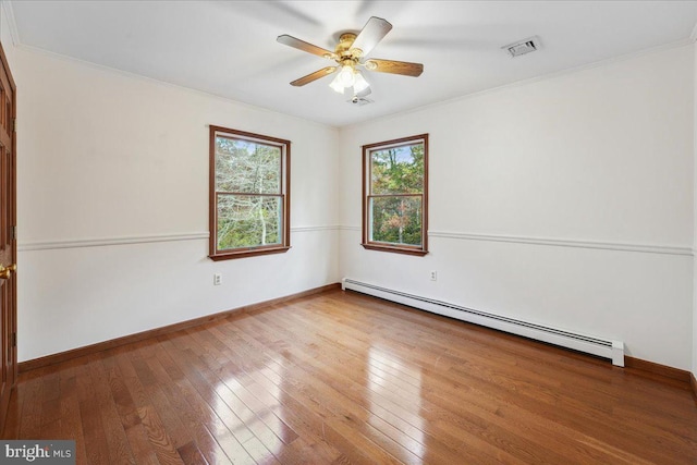 unfurnished room featuring a baseboard heating unit, wood-type flooring, visible vents, and a ceiling fan