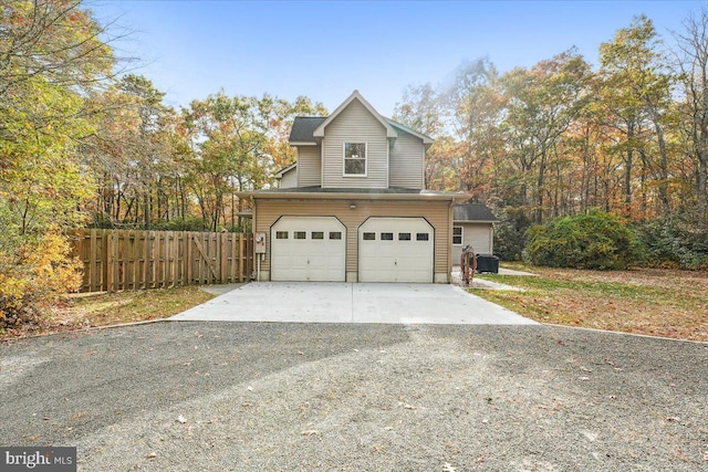 view of property exterior with fence and driveway