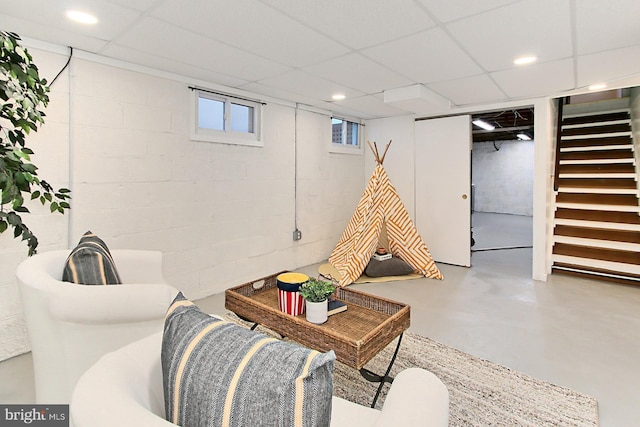 living room featuring stairway, a paneled ceiling, recessed lighting, and finished concrete floors