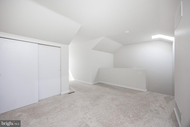 additional living space with carpet and lofted ceiling