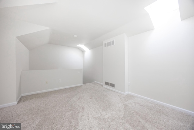 additional living space featuring lofted ceiling, carpet, visible vents, and baseboards