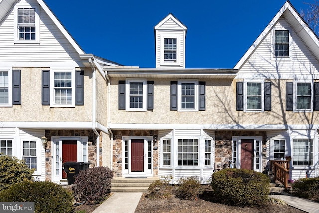 multi unit property with stucco siding and stone siding