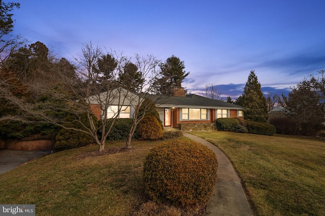 view of front of property with stone siding and a front yard