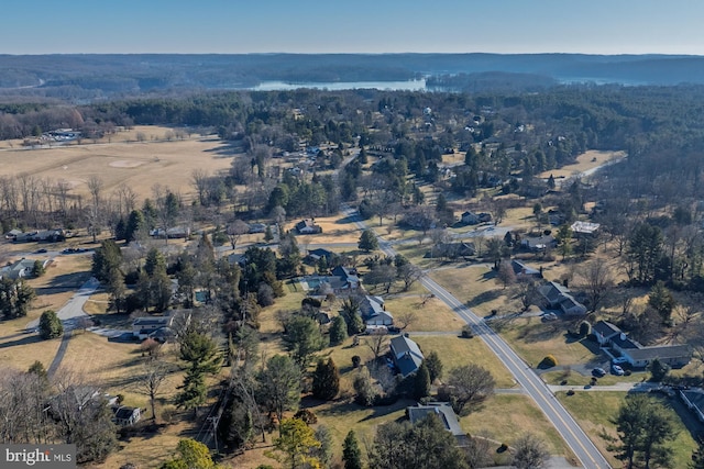 birds eye view of property featuring a view of trees and a rural view