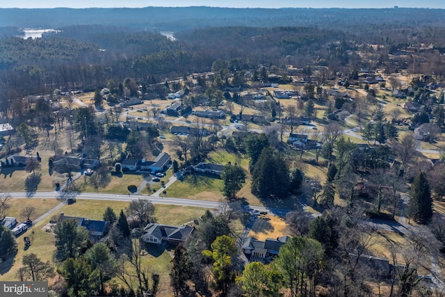 birds eye view of property with a wooded view