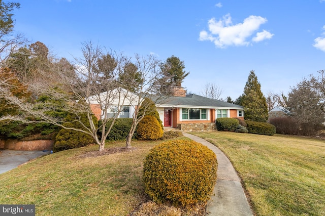 view of front of house with a front yard, stone siding, and a chimney