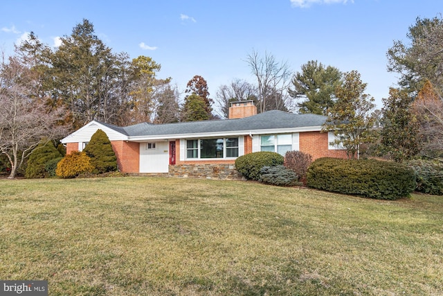 single story home with a front yard, brick siding, and a chimney