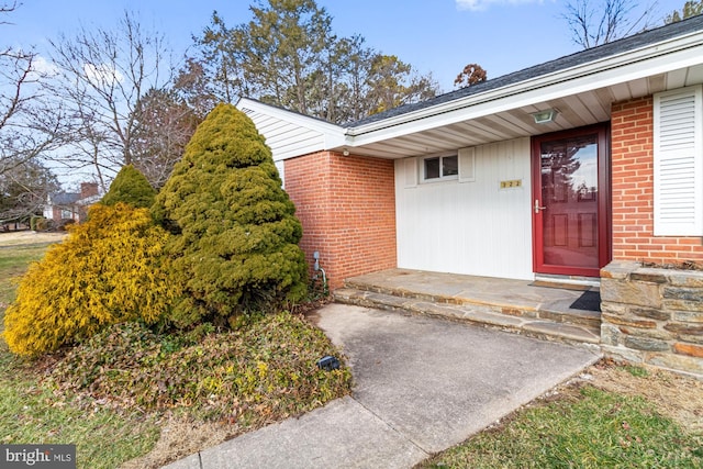 property entrance with brick siding