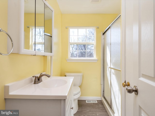 full bathroom featuring visible vents, vanity, toilet, and a shower stall