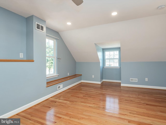 bonus room with visible vents and wood finished floors