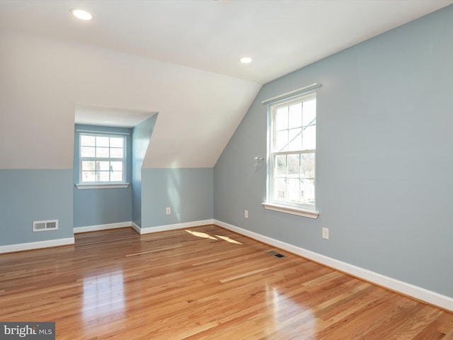 bonus room with visible vents, baseboards, and light wood-style floors