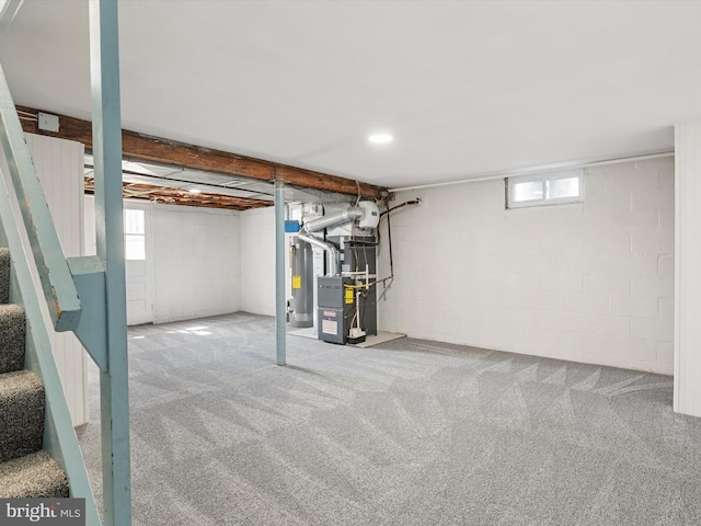 basement with recessed lighting, heating unit, carpet, and water heater