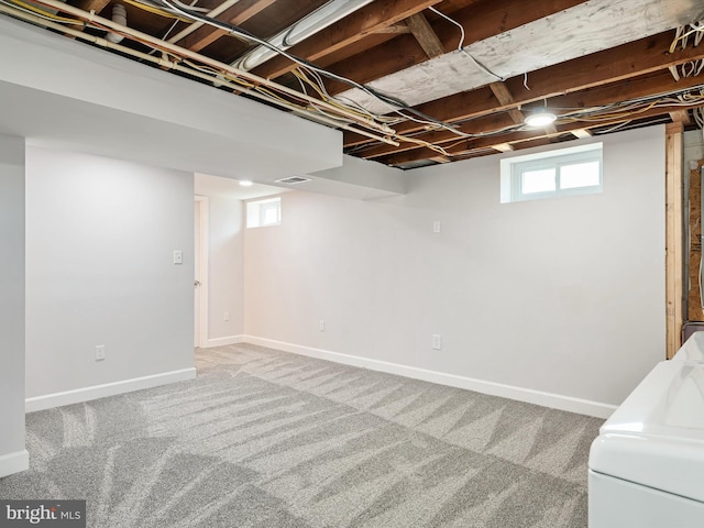 basement with washer / dryer, carpet, and baseboards