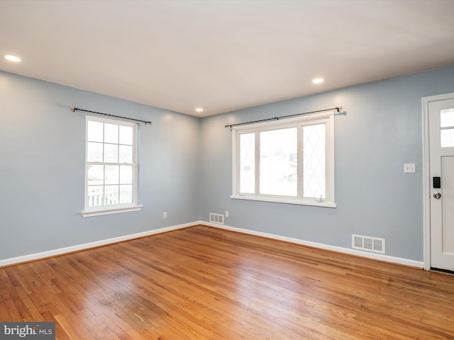 interior space with recessed lighting, visible vents, light wood-style flooring, and baseboards