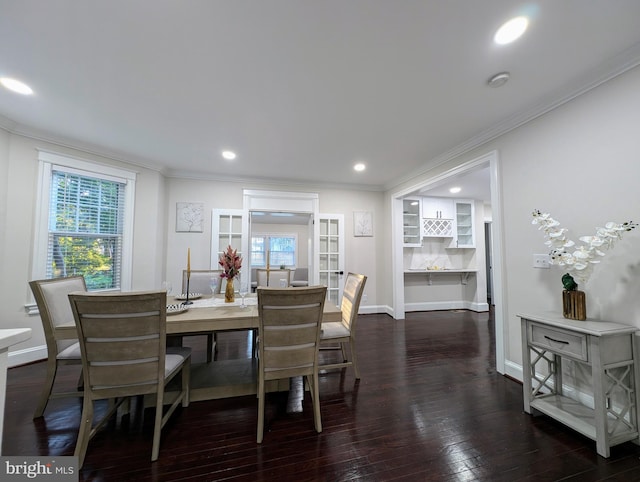 dining area with ornamental molding and hardwood / wood-style flooring