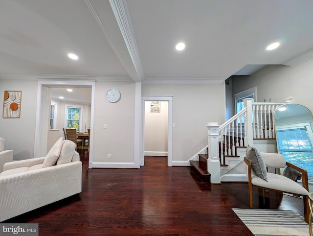 living room featuring stairway, ornamental molding, baseboards, and wood finished floors