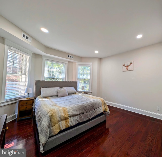 bedroom featuring recessed lighting, wood finished floors, visible vents, and baseboards