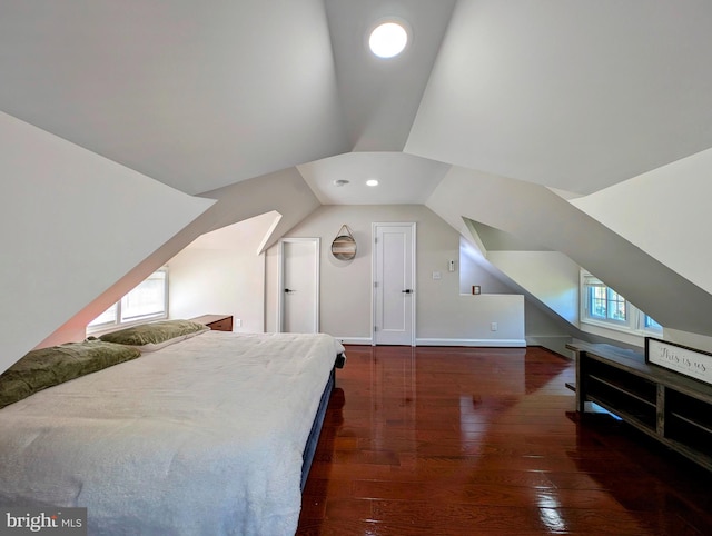 bedroom with lofted ceiling and wood-type flooring