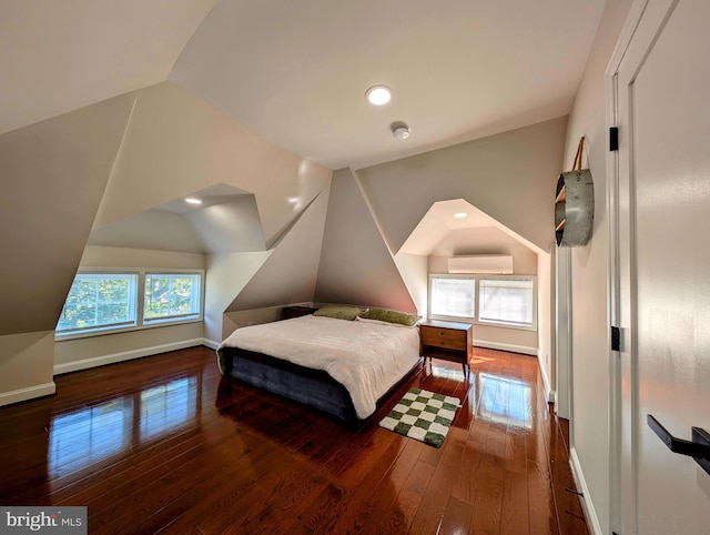 bedroom with hardwood / wood-style floors, baseboards, lofted ceiling, recessed lighting, and an AC wall unit