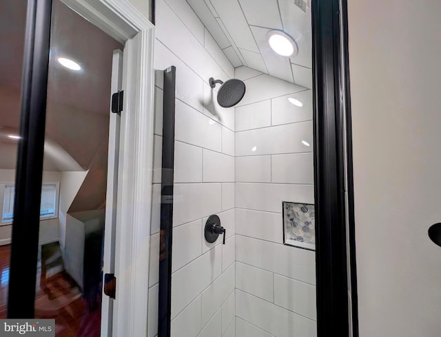 interior details with tiled shower and wood finished floors