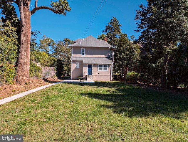 view of front of property with entry steps and a front yard