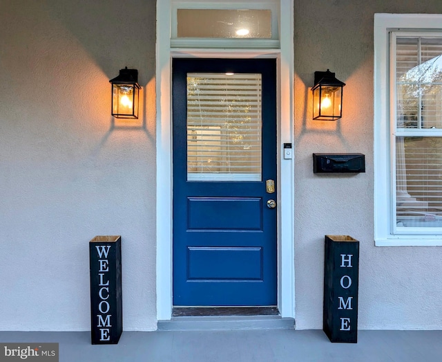 property entrance featuring stucco siding