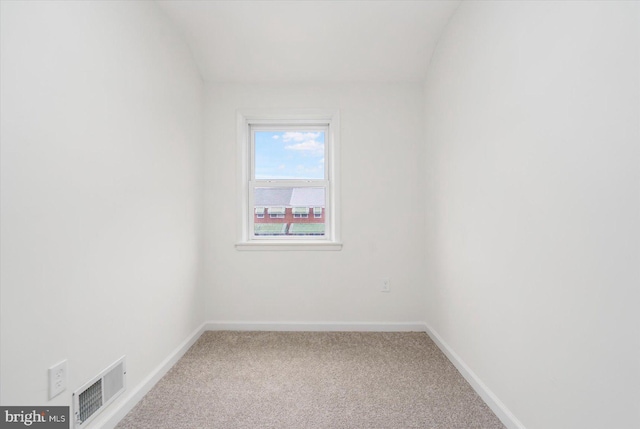 carpeted empty room featuring visible vents and baseboards