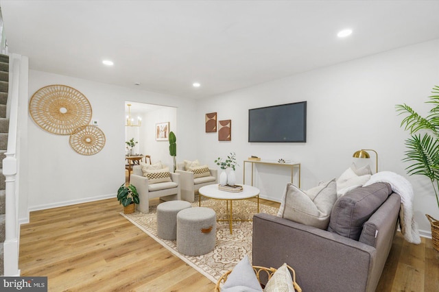 living area featuring stairway, recessed lighting, wood finished floors, and baseboards