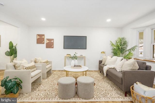 living room featuring recessed lighting, baseboards, and wood finished floors