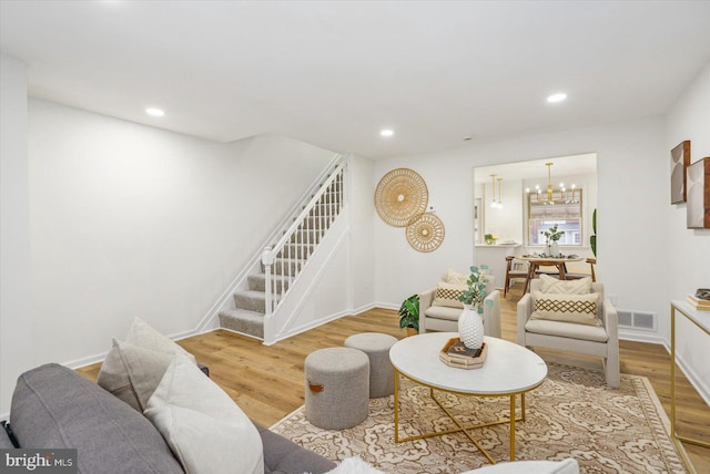 living area with stairs, recessed lighting, wood finished floors, and visible vents