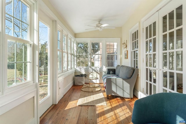 sunroom / solarium featuring hardwood / wood-style floors, lofted ceiling, and plenty of natural light