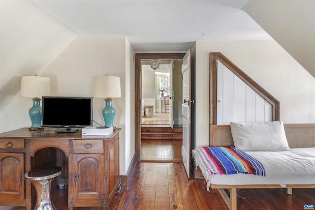 bedroom with hardwood / wood-style flooring and lofted ceiling