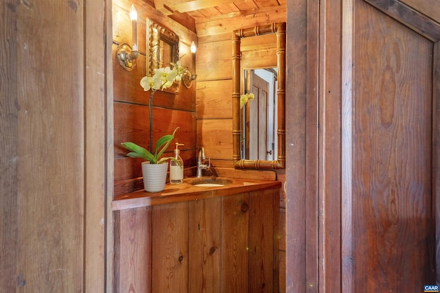interior space featuring wood walls, indoor wet bar, and vanity