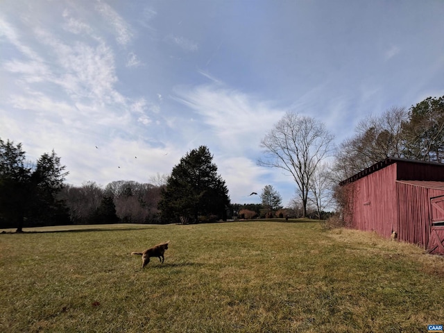 view of yard featuring an outdoor structure and an outbuilding