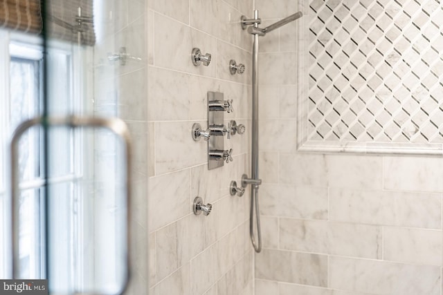 full bath with a tile shower